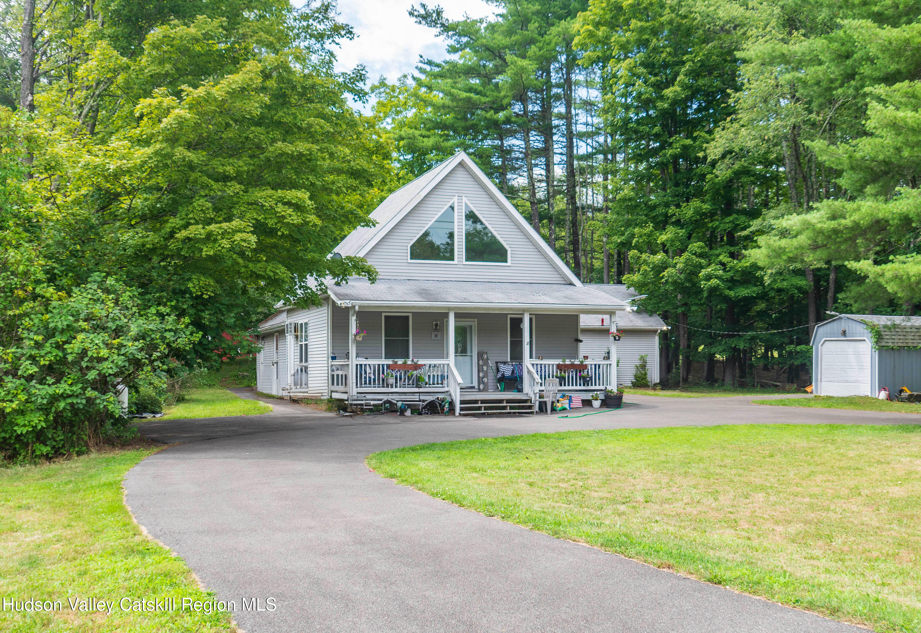 a front view of house with outdoor seating and yard