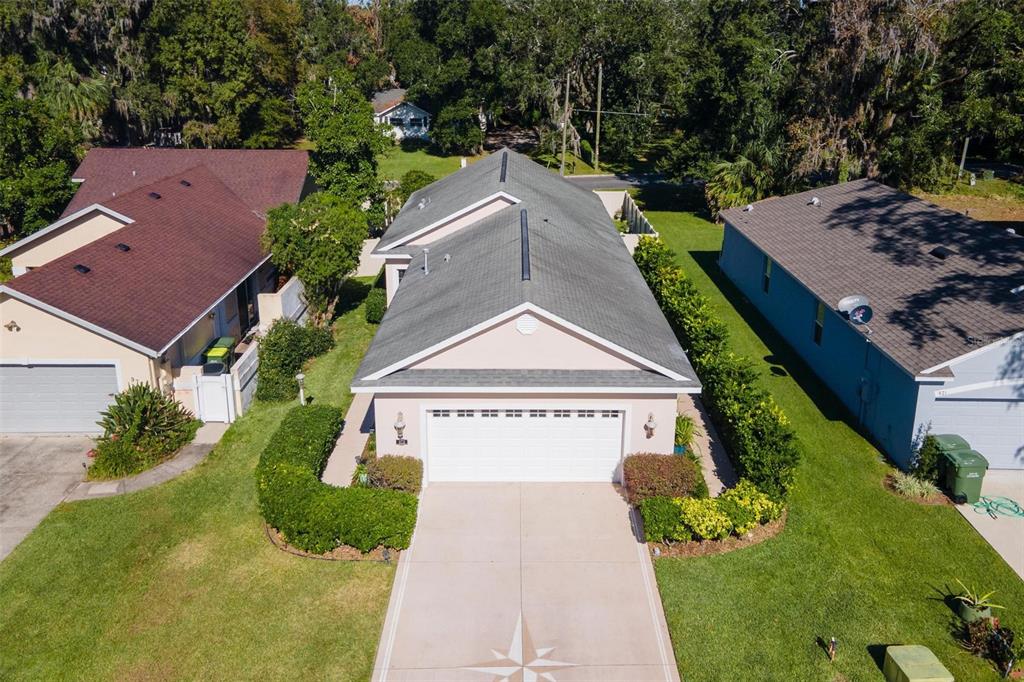 an aerial view of a house with a yard and potted plants