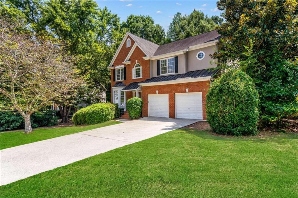 a front view of a house with a yard and garage