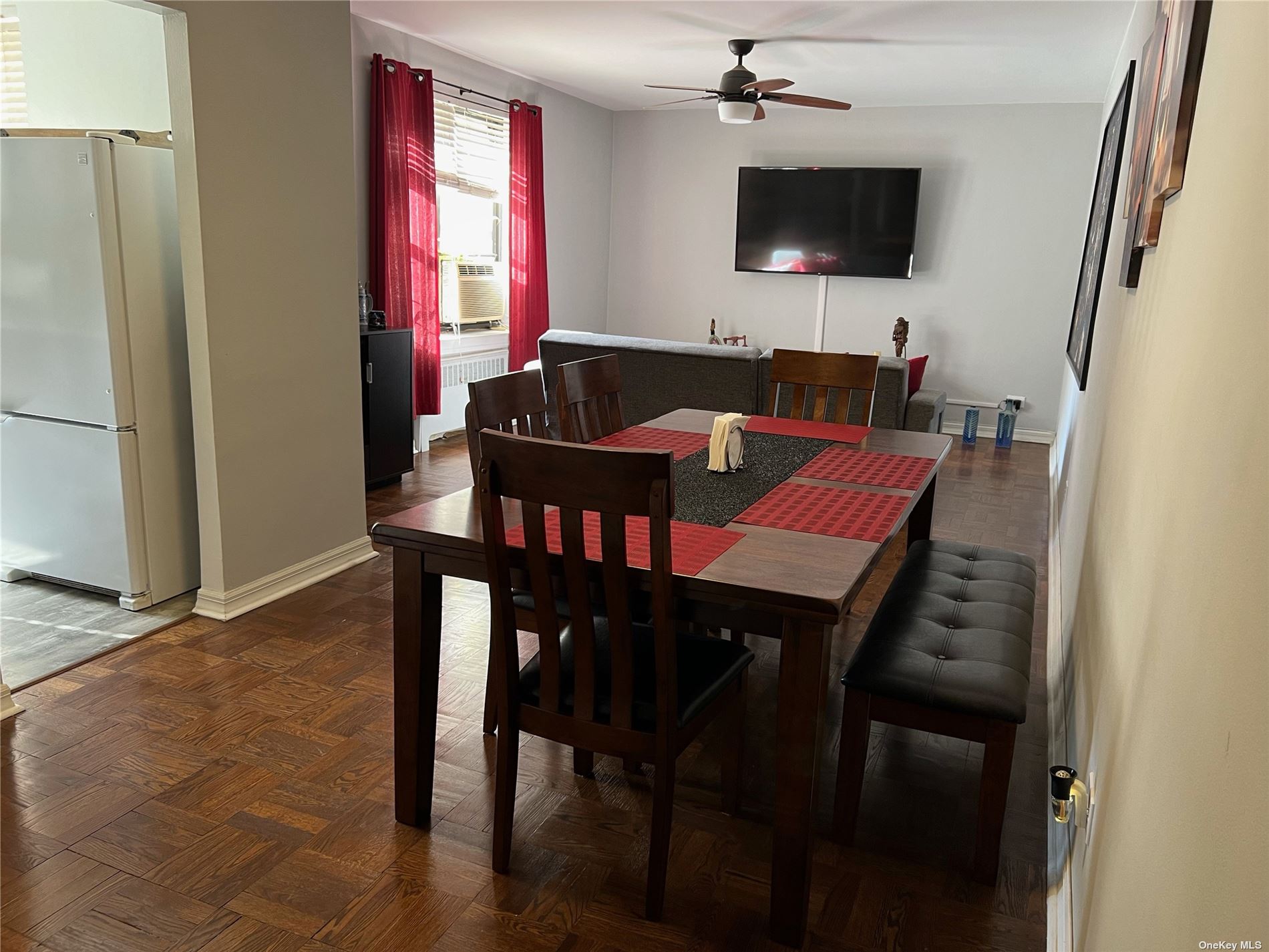 a kitchen with a table chairs refrigerator and microwave