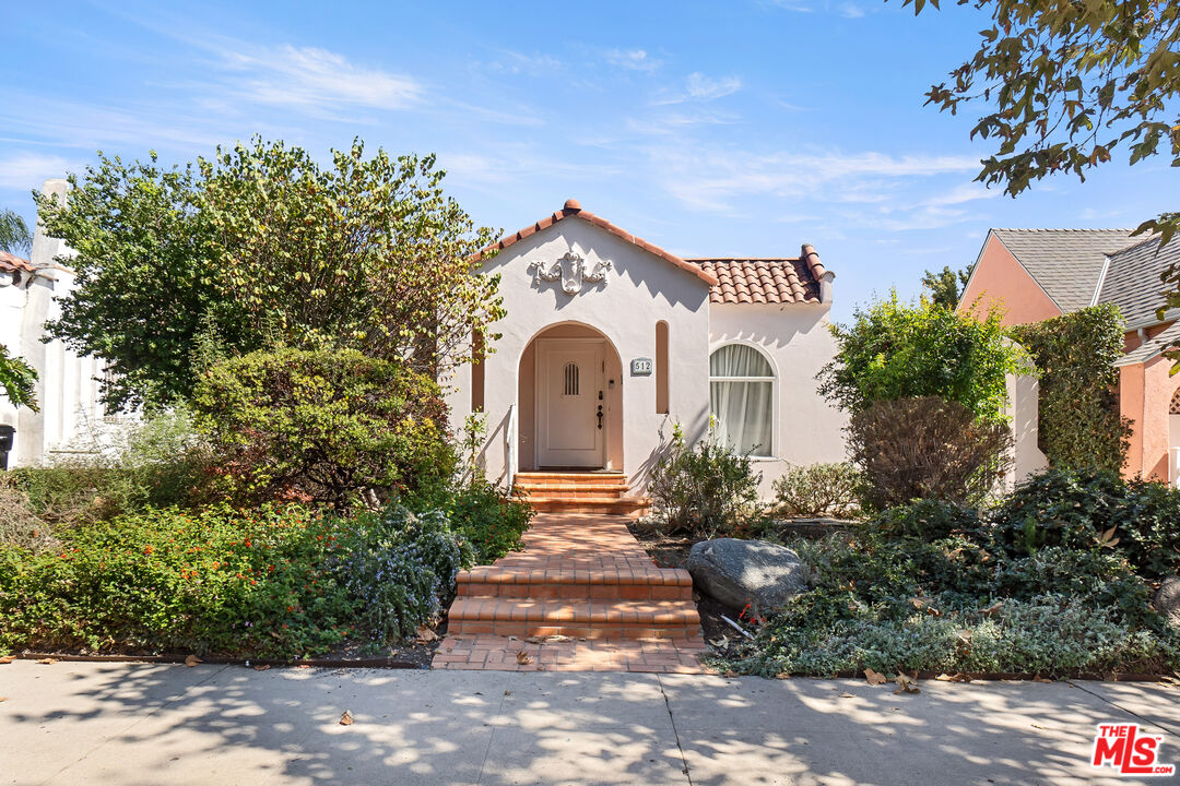 a view of a house with a yard and plants