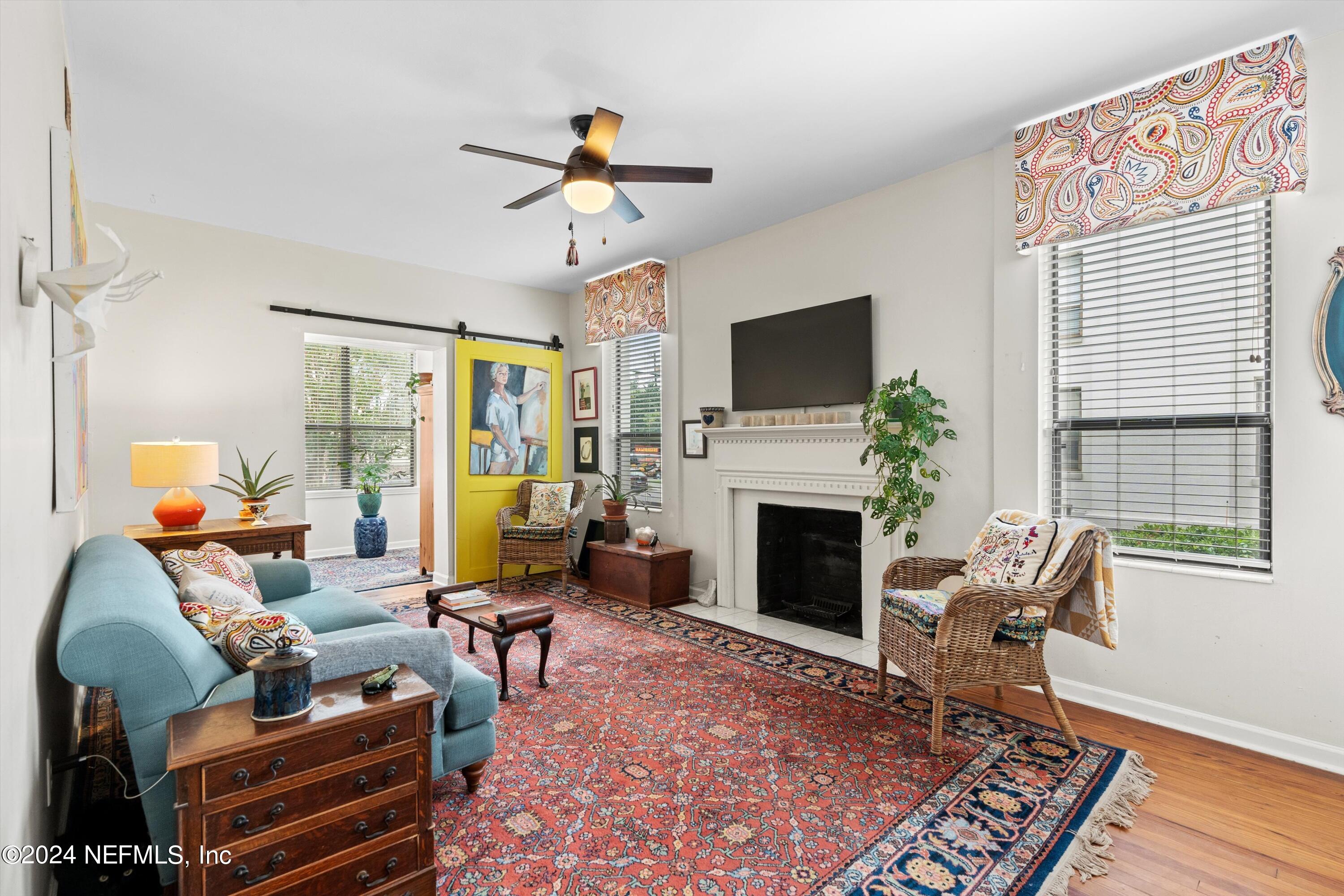 a living room with furniture a fireplace and a flat screen tv