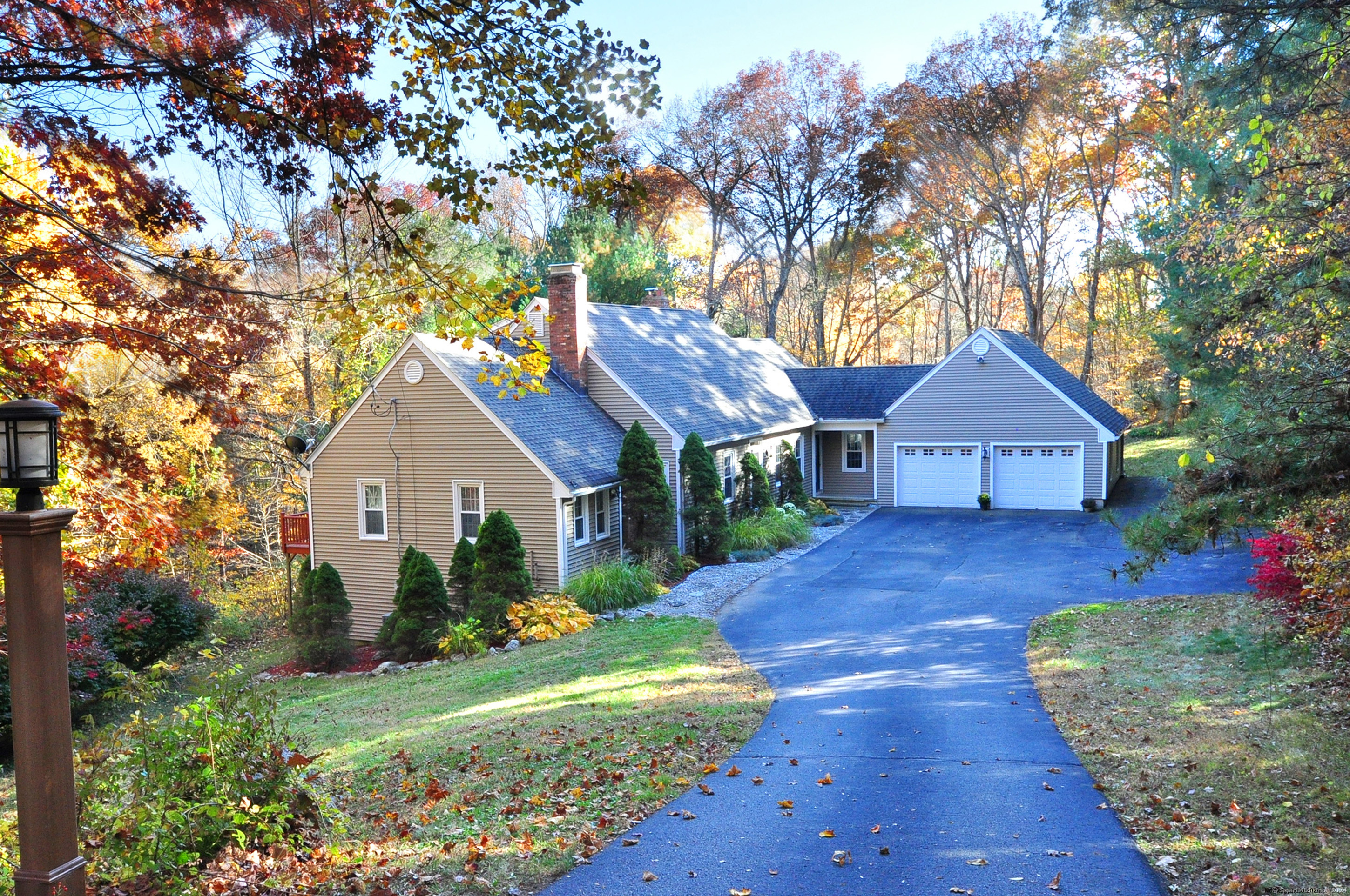 a view of house with wooden fence and a yard