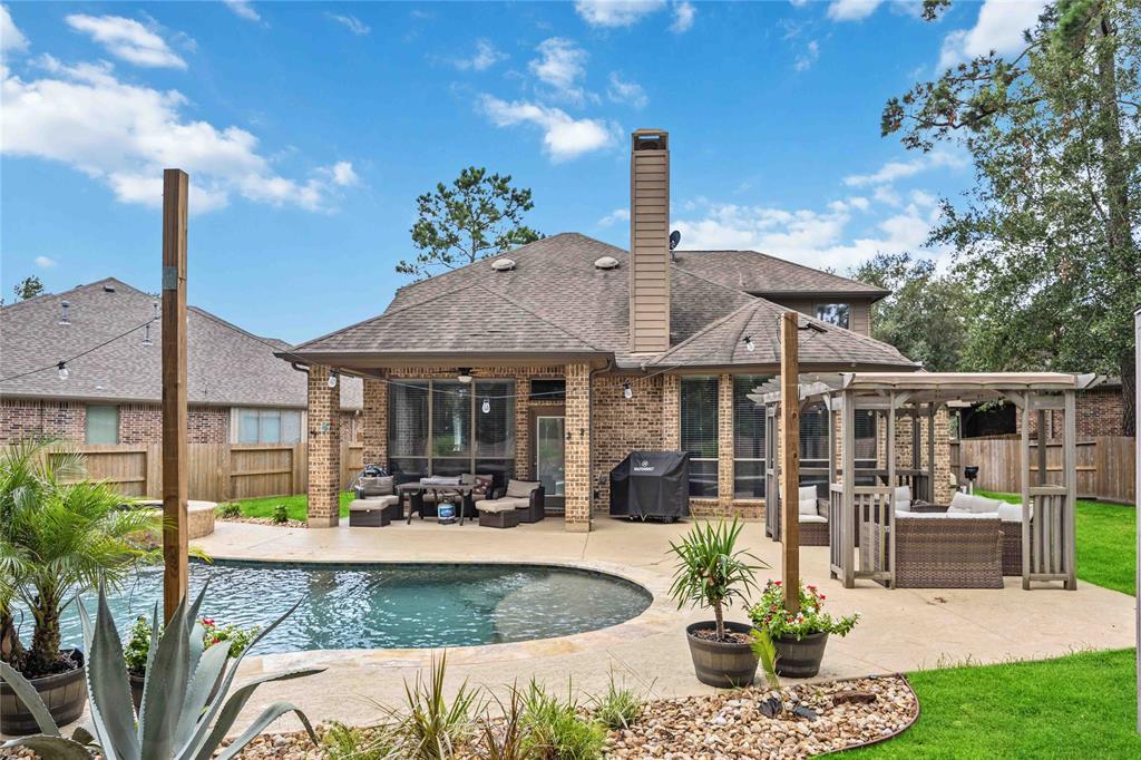 a view of a house with backyard porch and sitting area