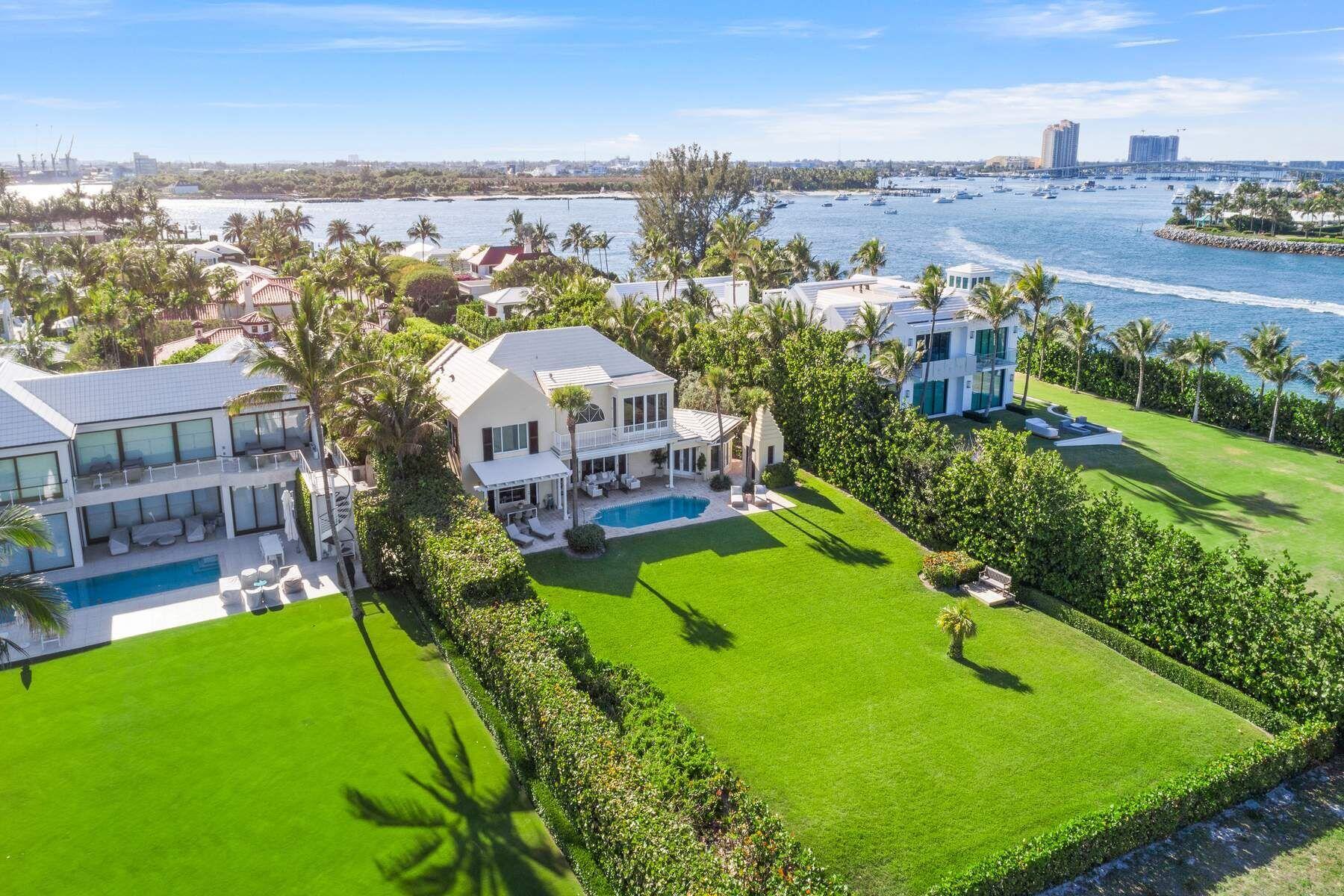 an aerial view of a house with a garden and lake view