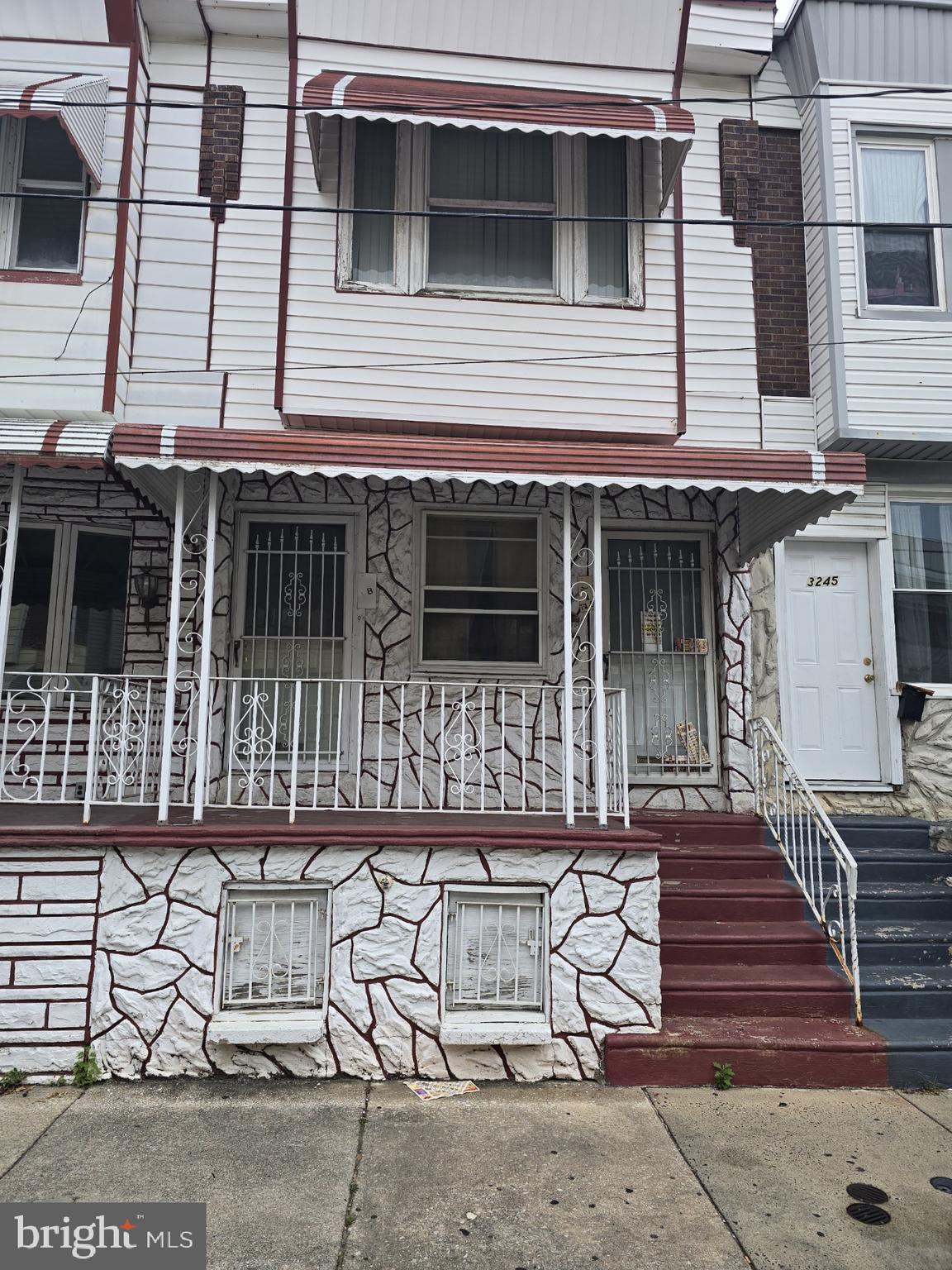 a front view of a house with stairs