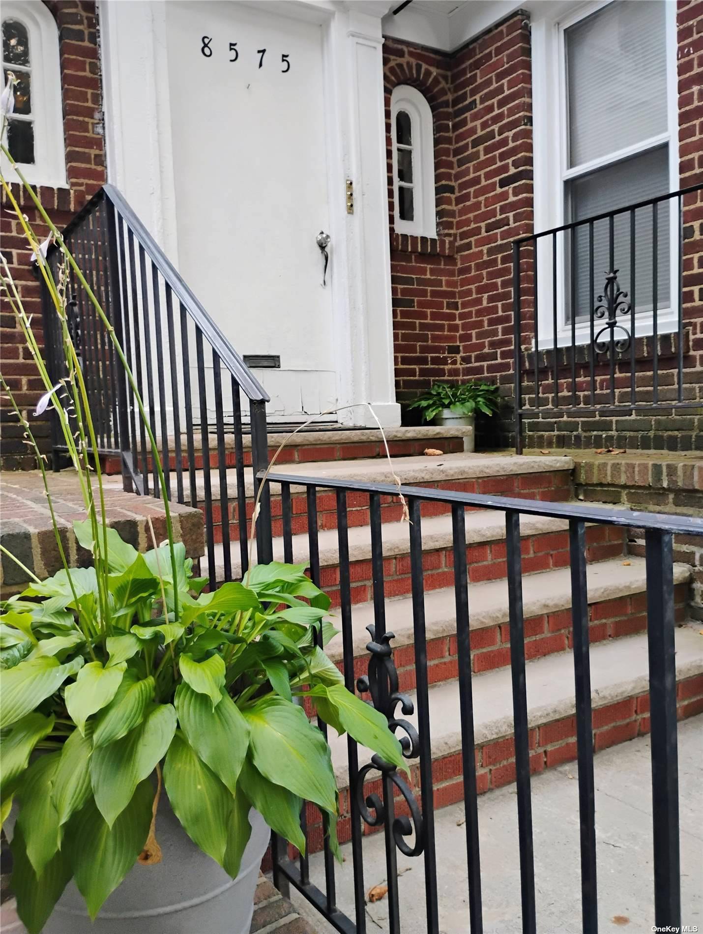 a view of a house with a small yard and deck