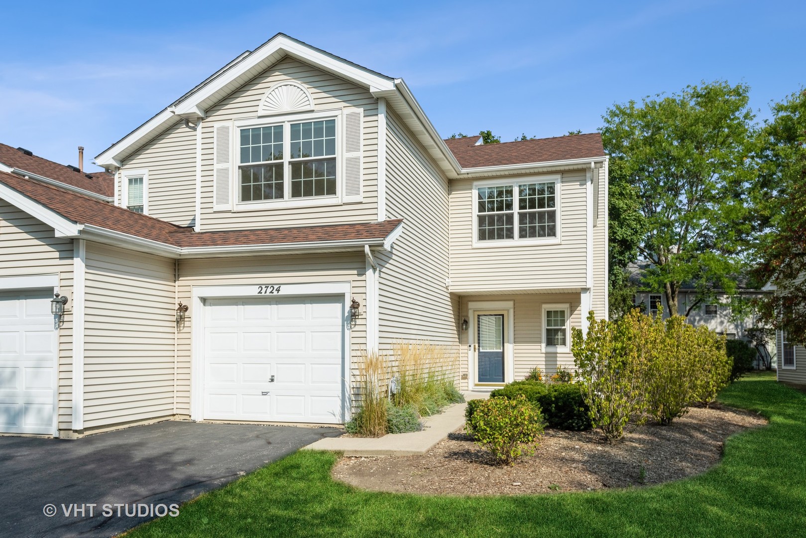 a front view of a house with a yard and garage