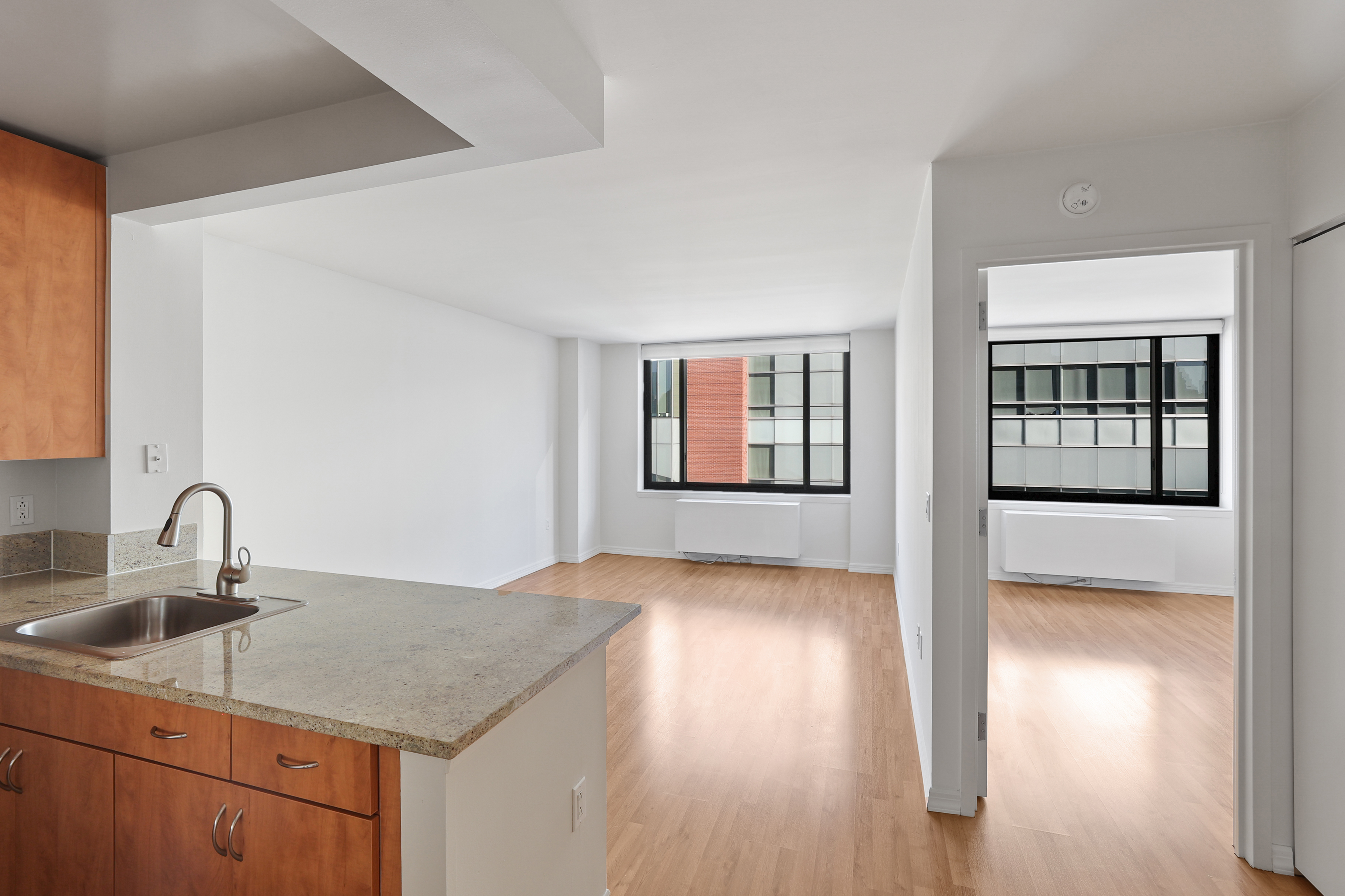 a kitchen with a sink cabinets and wooden floor