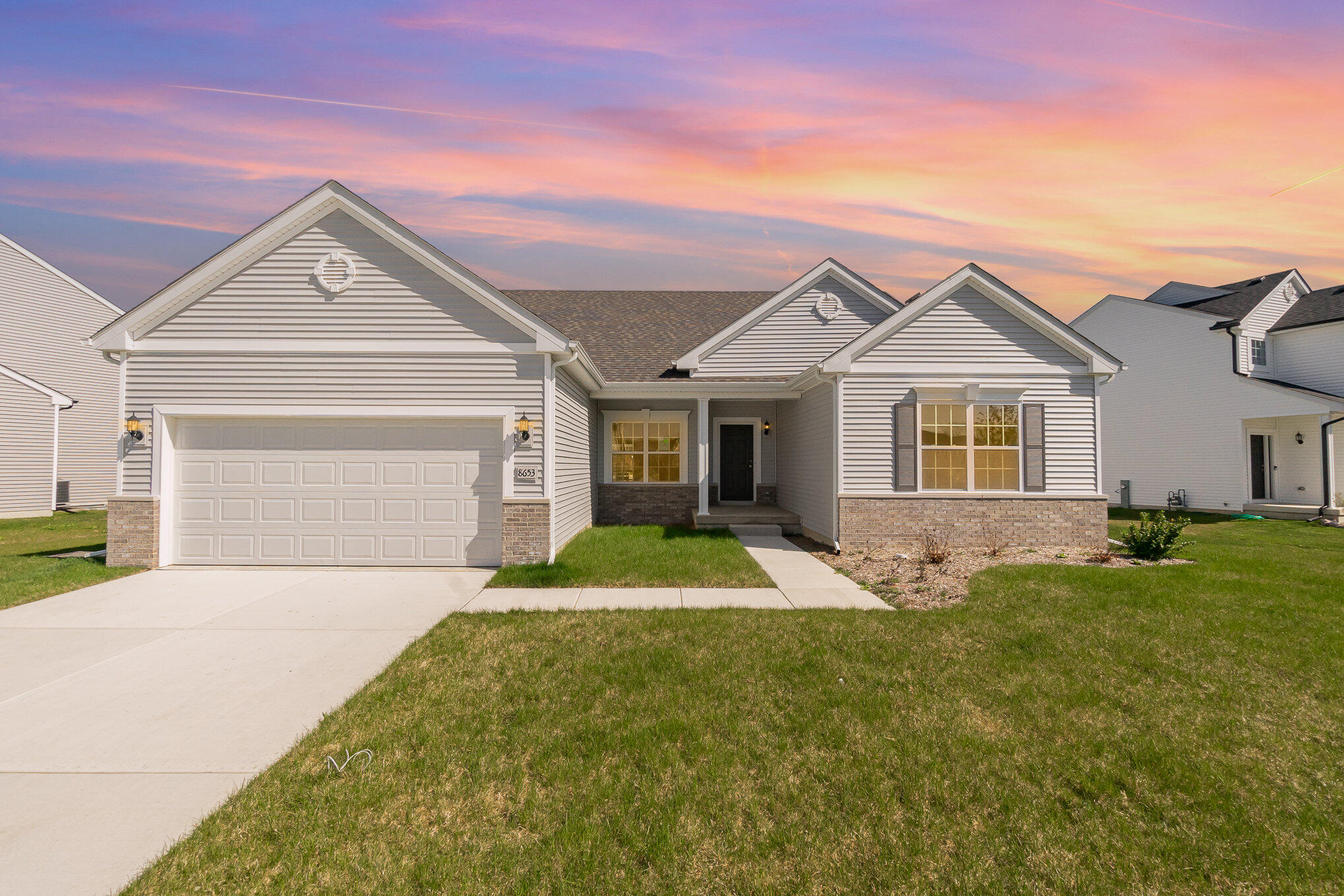 a front view of a house with a yard and garage