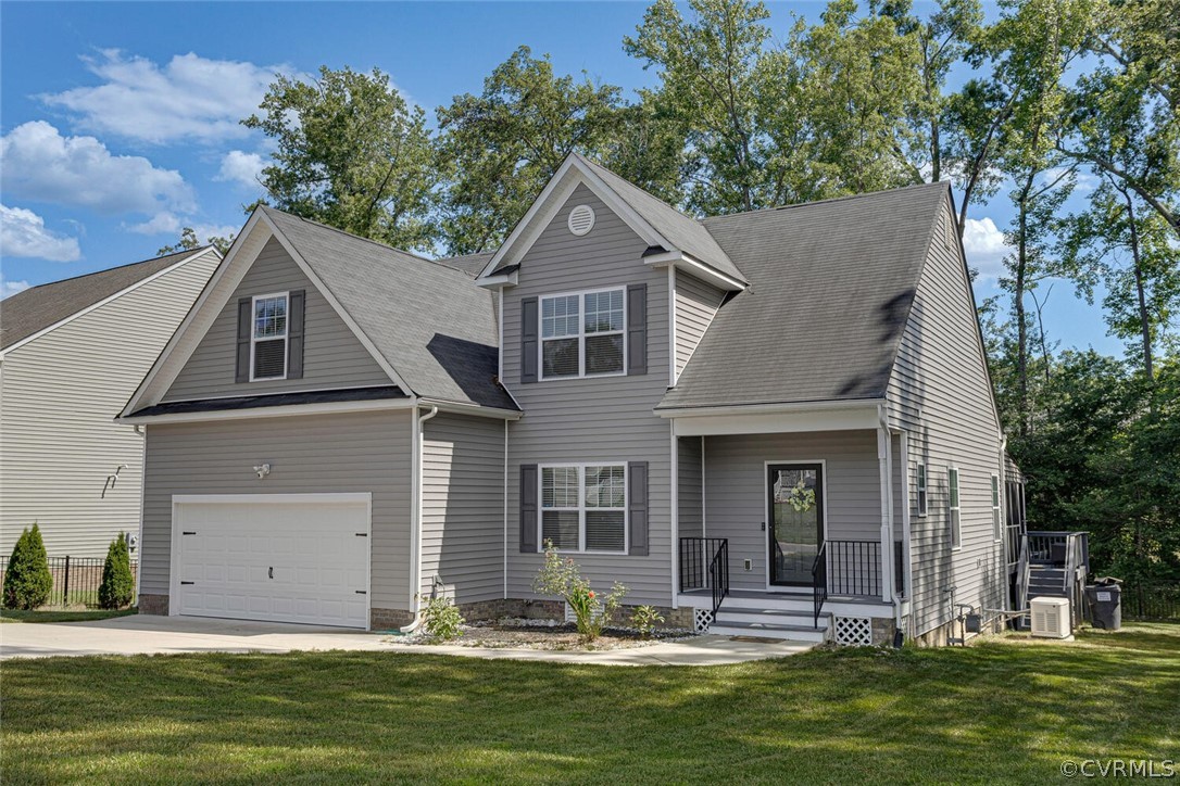 a front view of house with yard and trees in the background