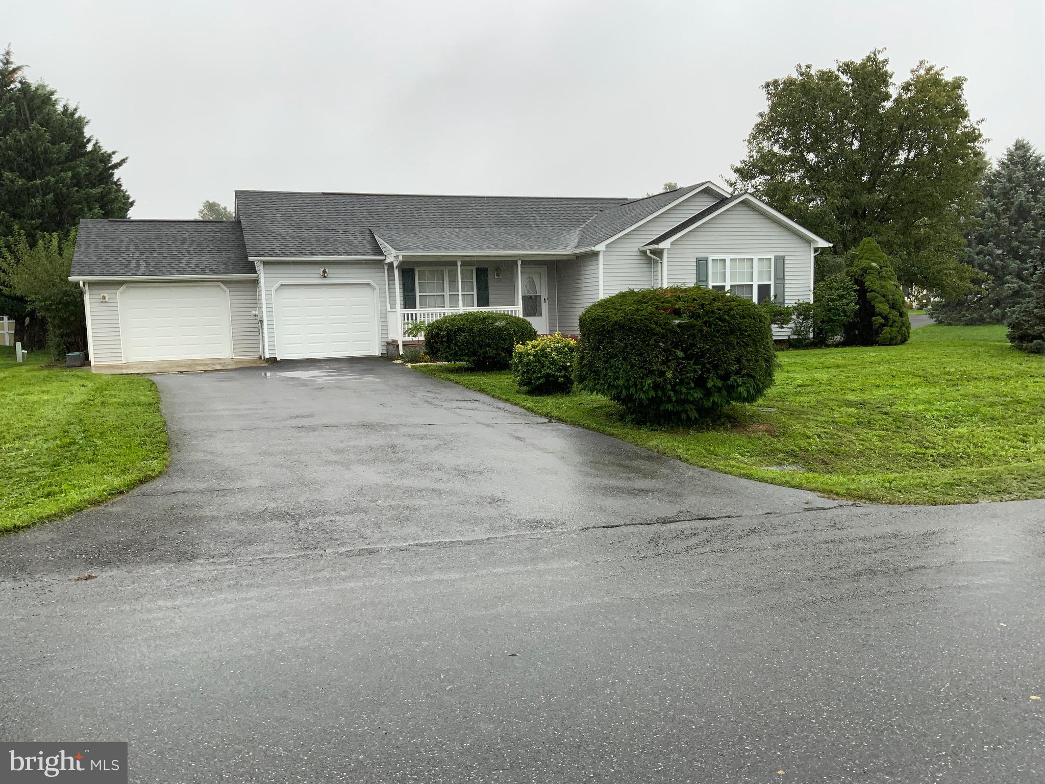 a front view of house with yard and green space