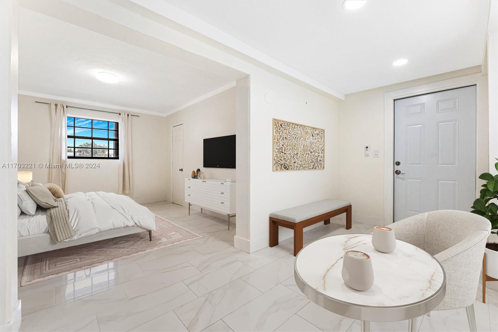 a spacious bedroom with a bed and glass window