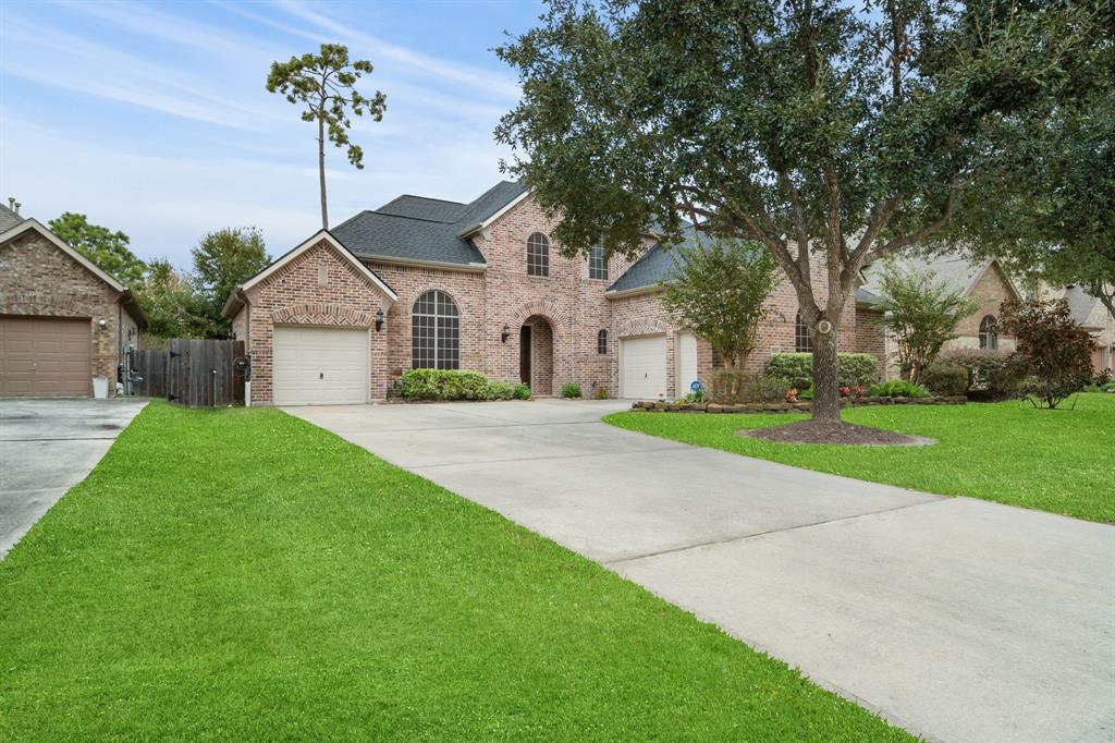 a front view of a house with a garden and trees