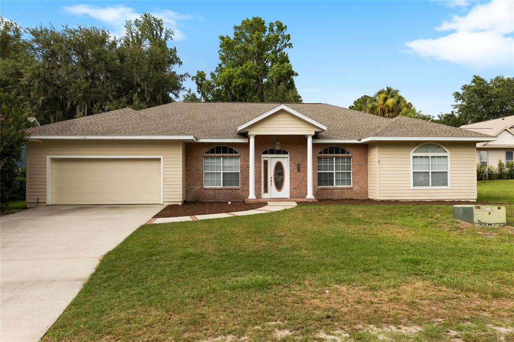 a front view of a house with a garden