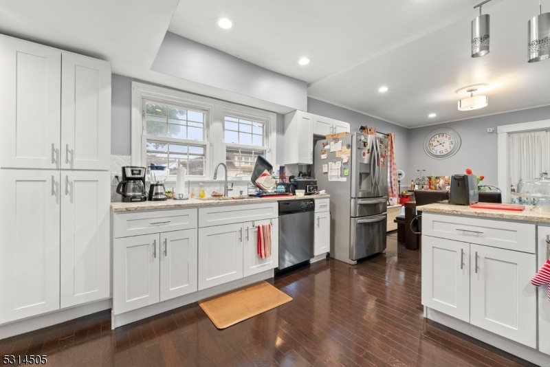 a kitchen with refrigerator and cabinets