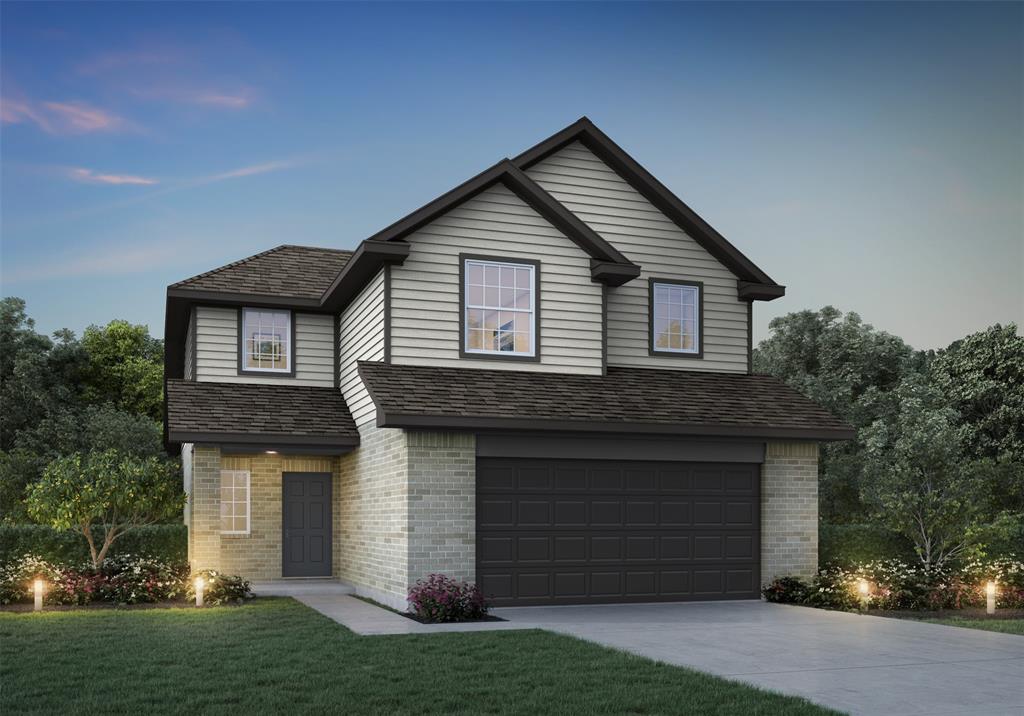 a front view of a house with a garden and garage