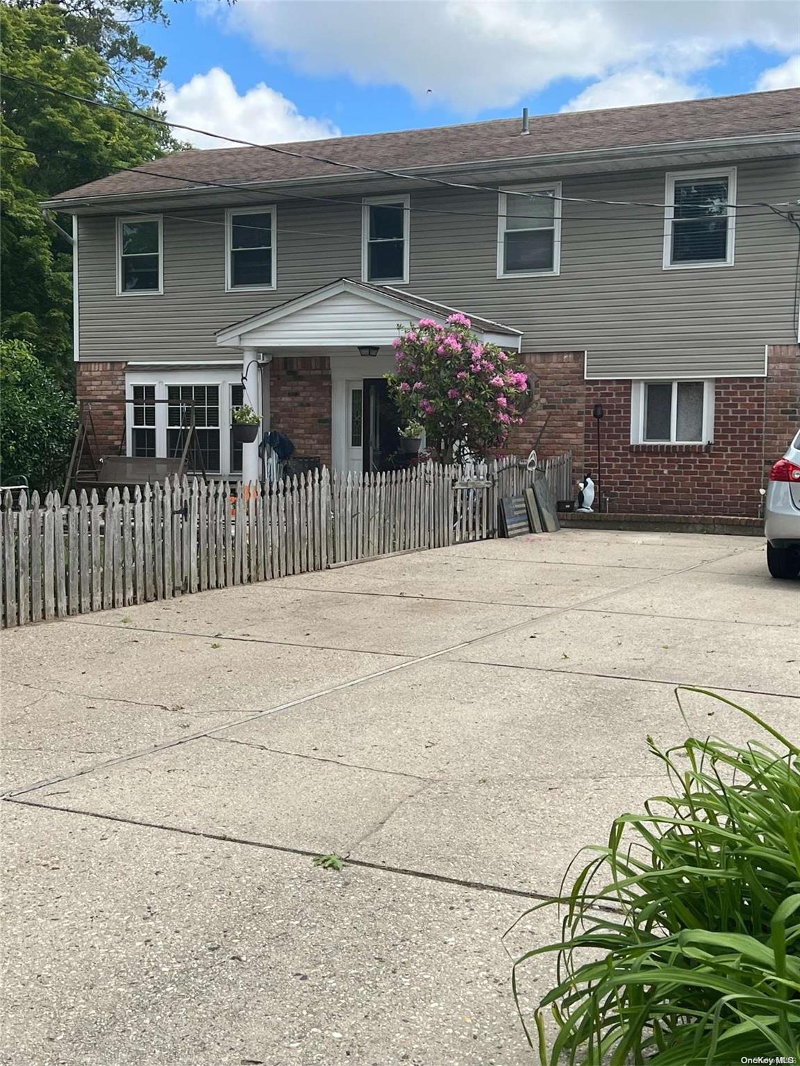 a front view of a house with a garden