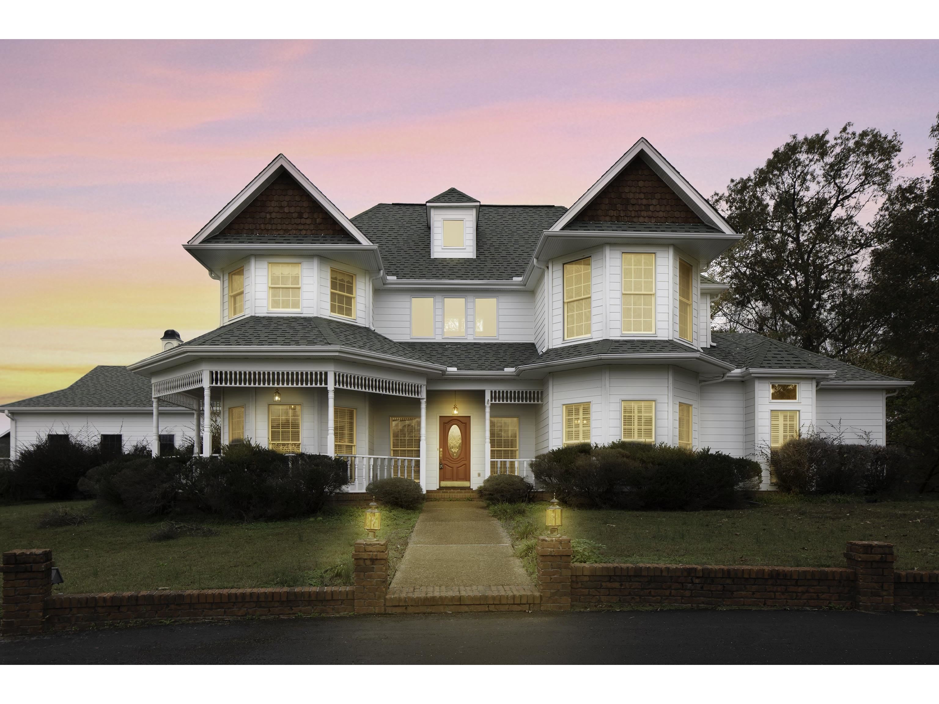 Victorian house featuring a porch and a yard