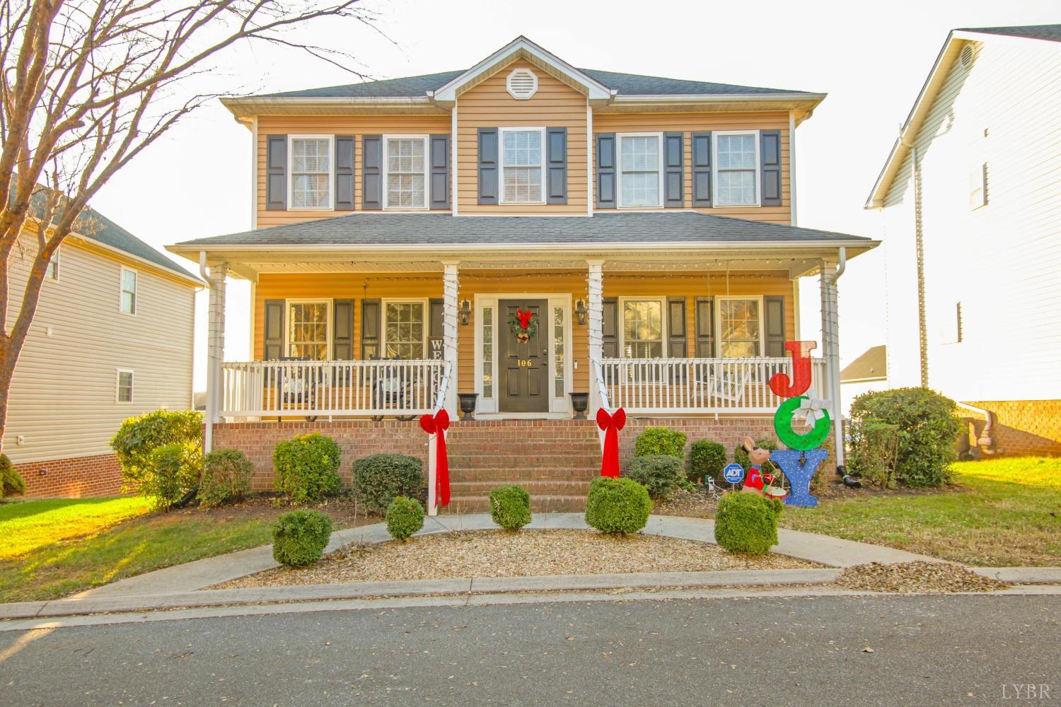 a front view of a house with a yard and a garage