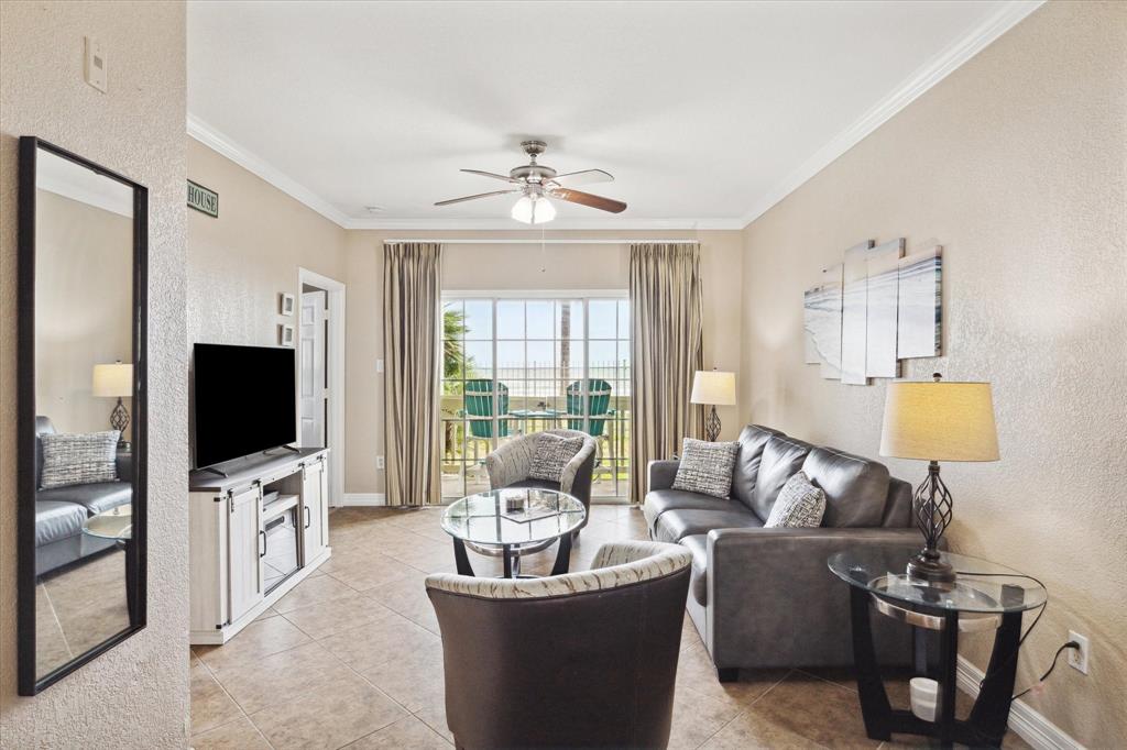 a living room with furniture a flat screen tv and a large window