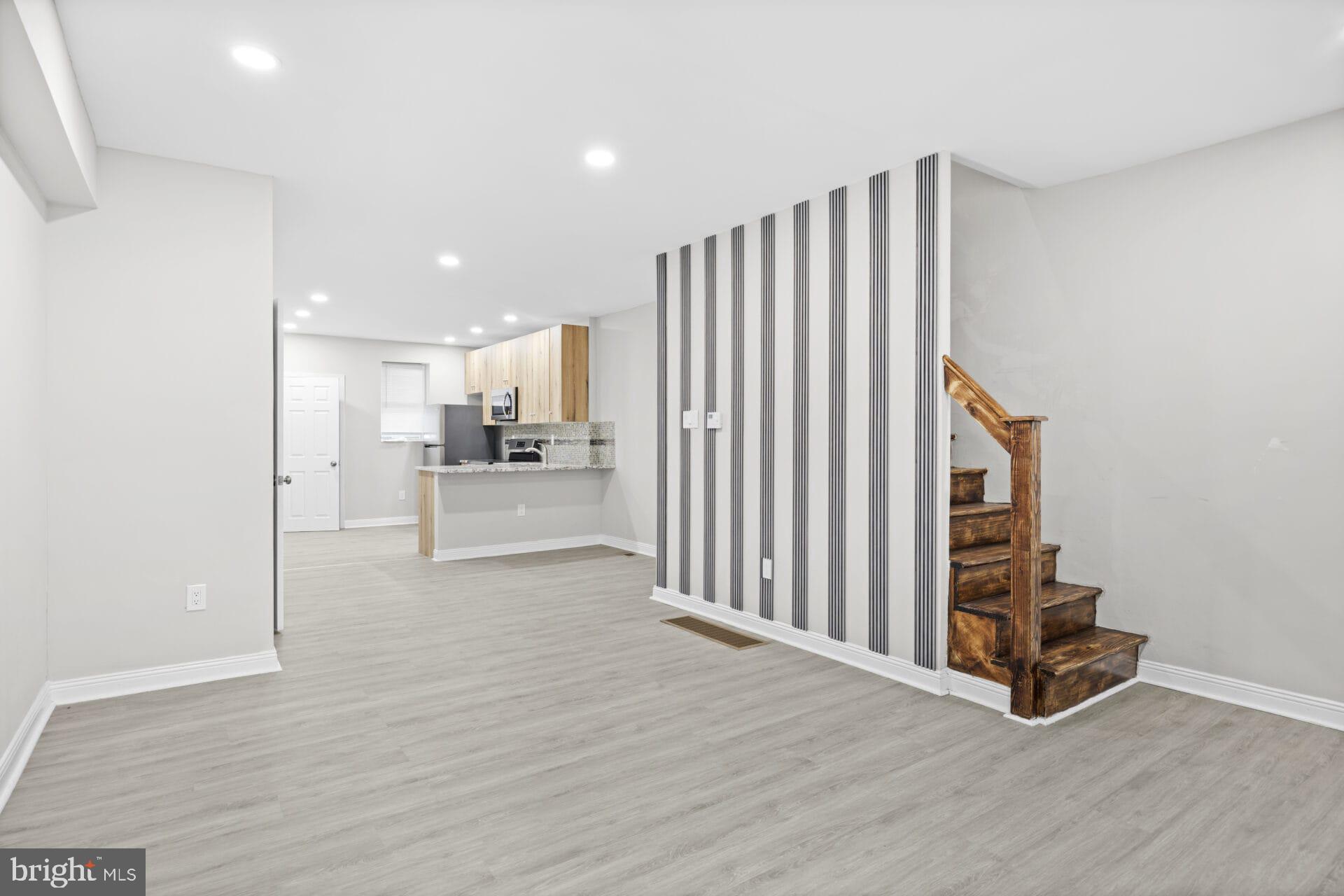 a view of kitchen with furniture and wooden floor