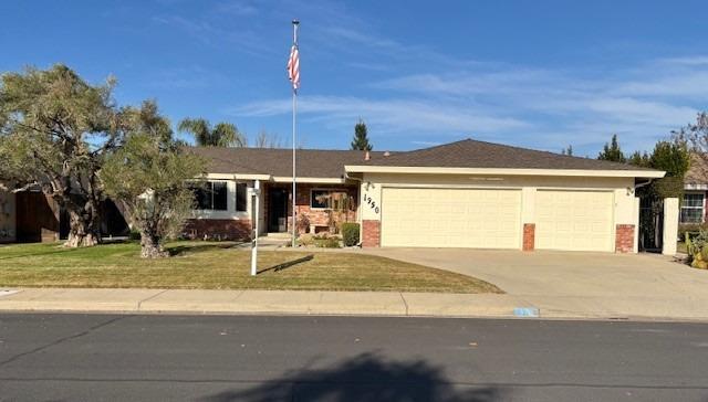 a view of a house with a patio and a yard