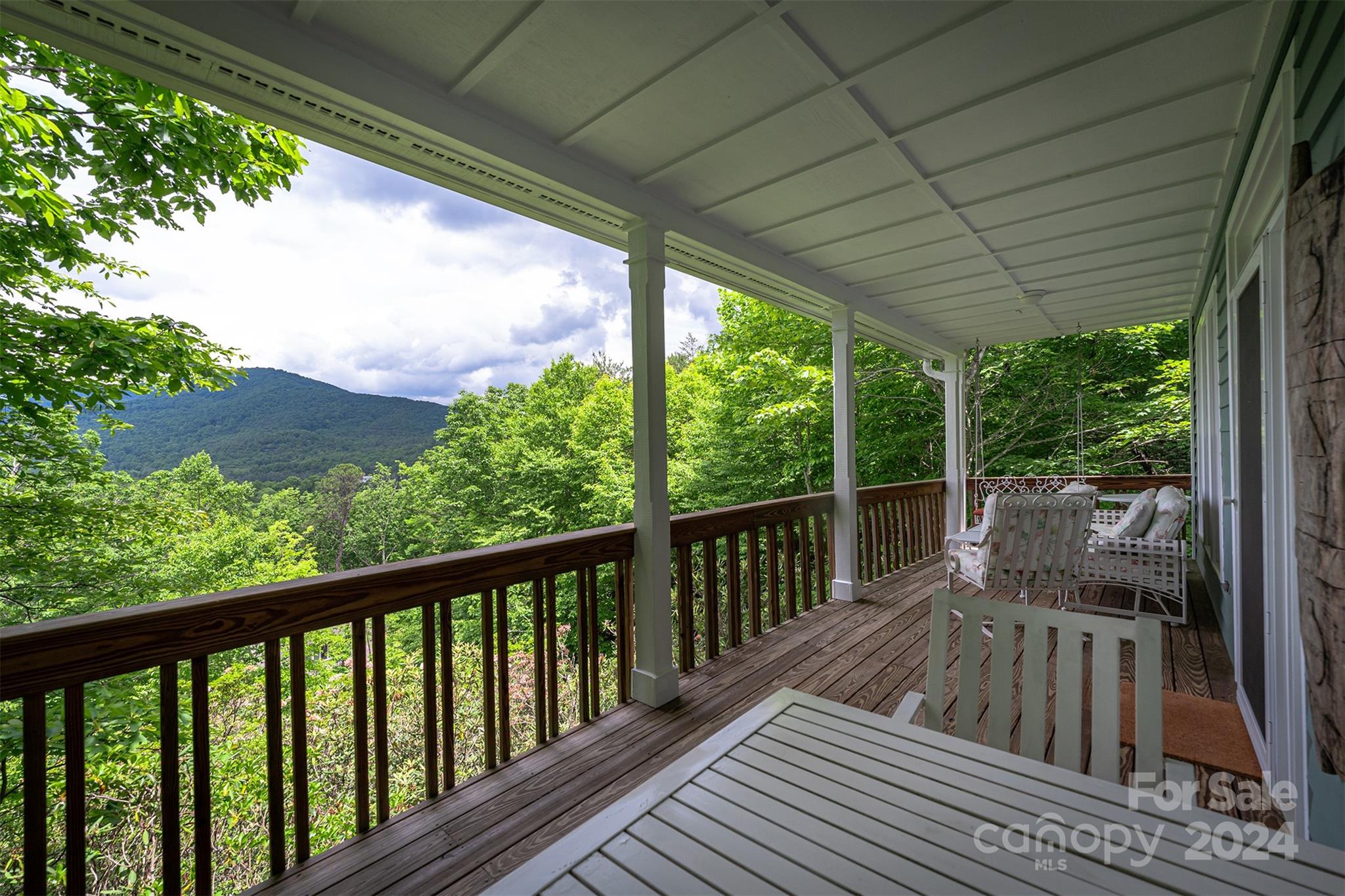 a view of balcony with couch and wooden floor