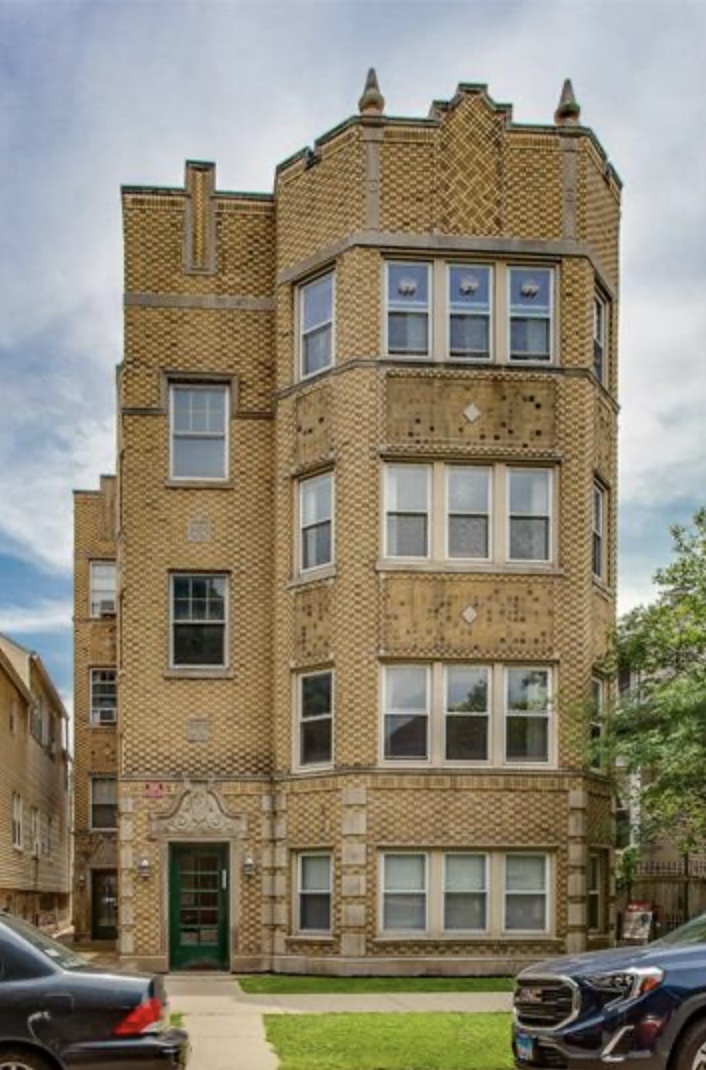 a front view of a building with parking space