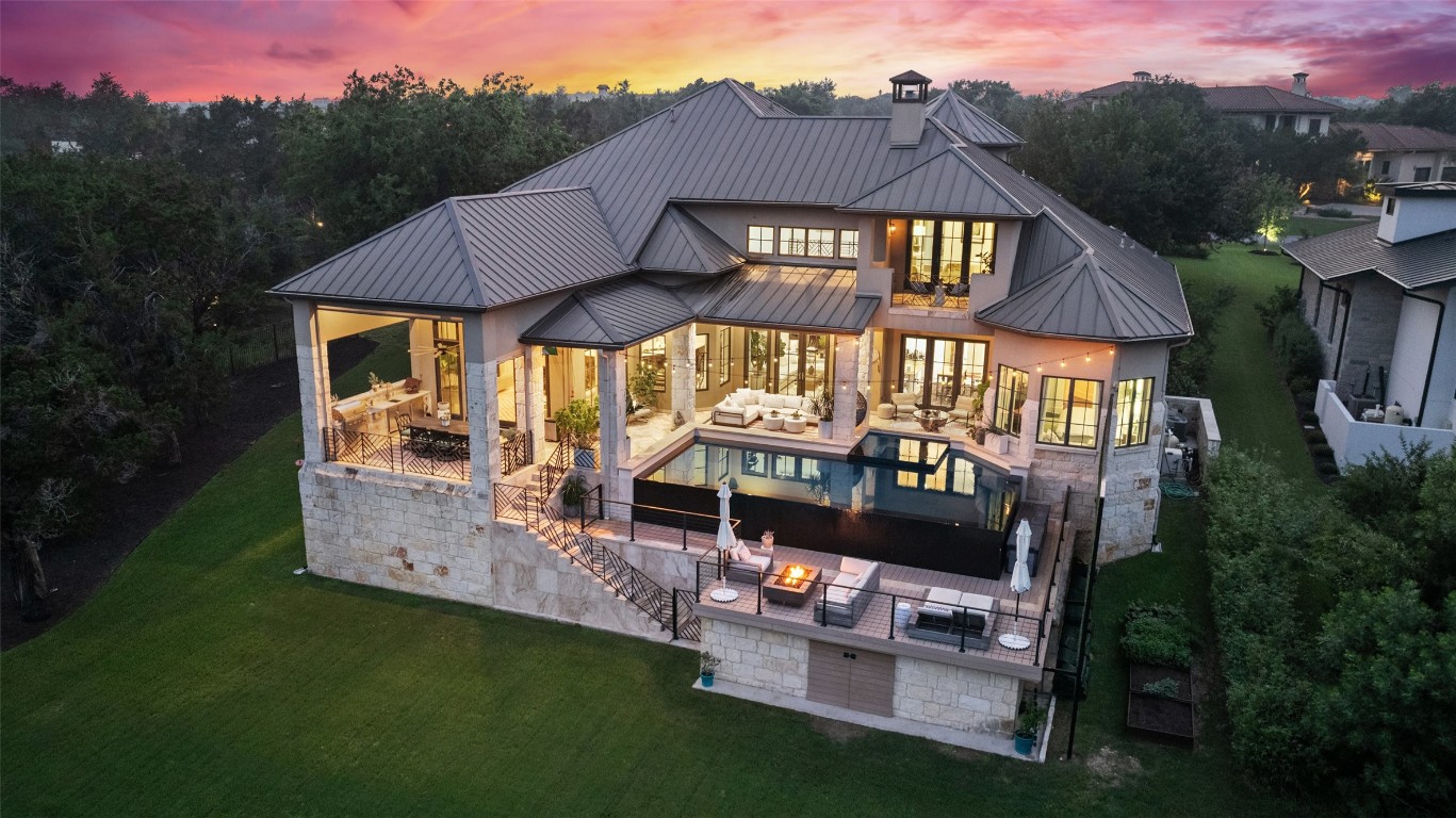 a backyard of a house with table and sofas