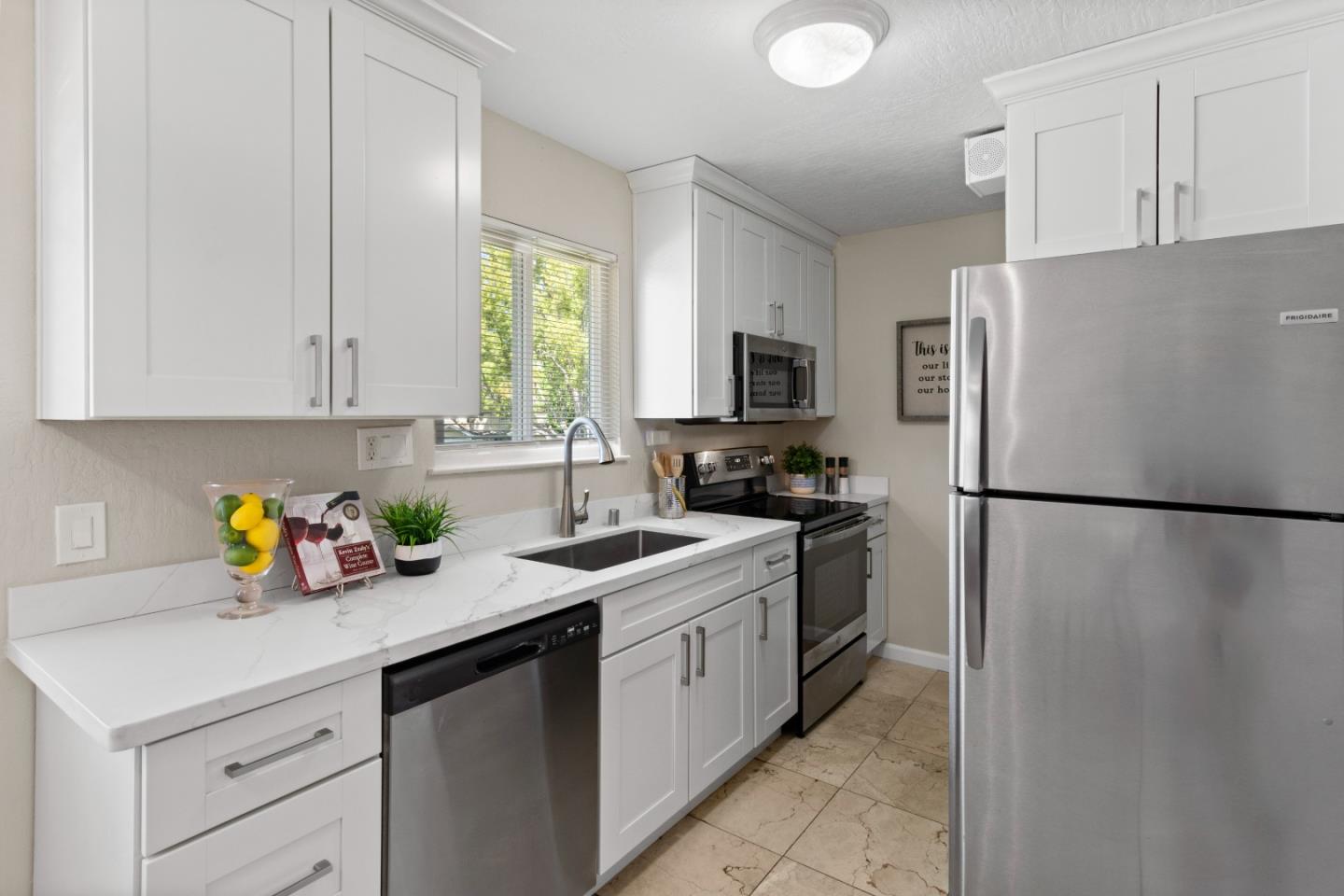 a kitchen with a refrigerator a white cabinets and a refrigerator