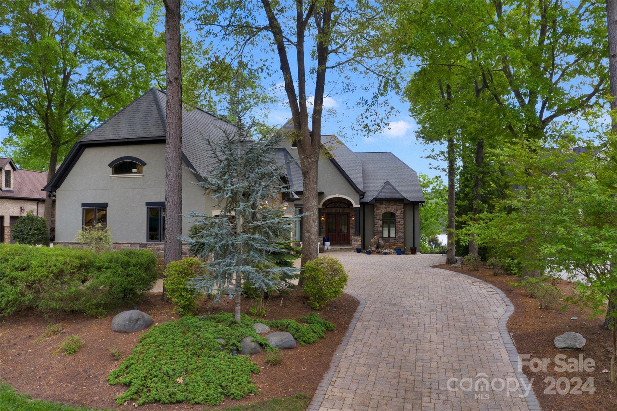 a front view of a house with yard and green space