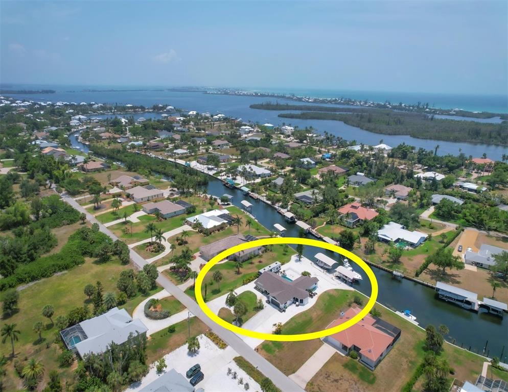 an aerial view of residential houses with outdoor space and swimming pool