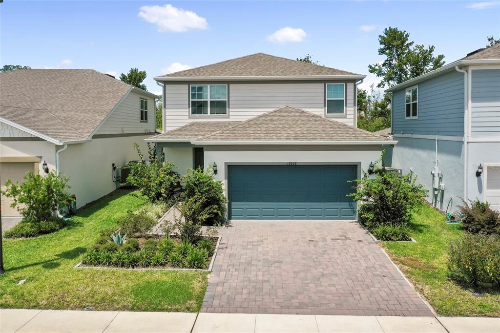 a front view of a house with garden