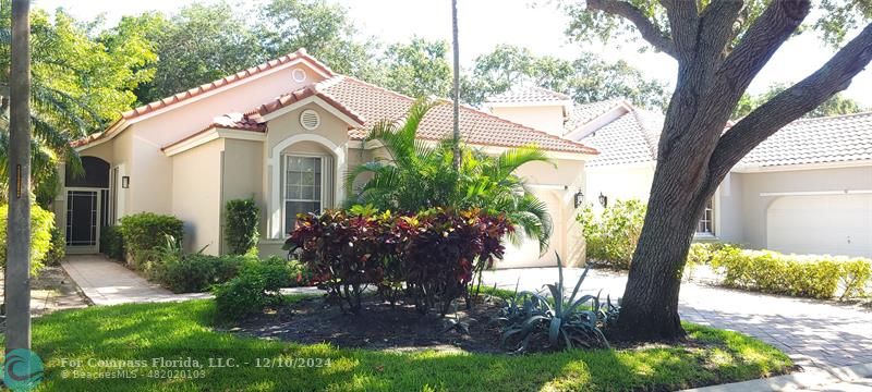 a view of a house with a yard and garden