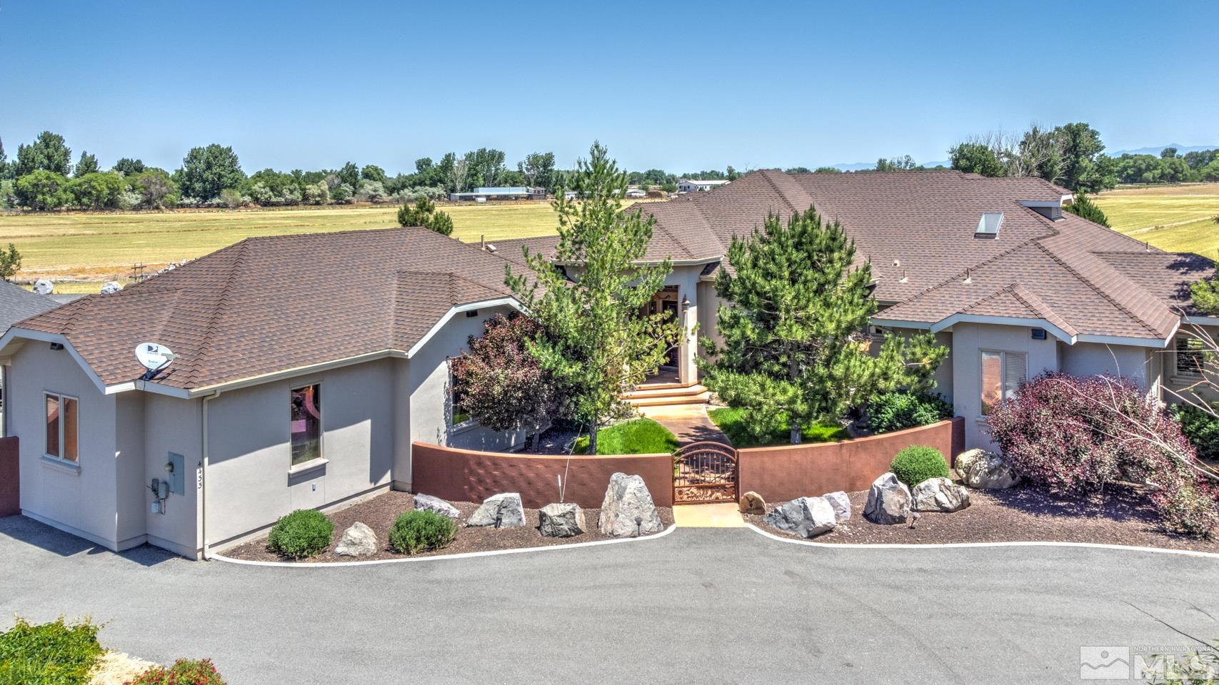 an aerial view of a house with a yard and outdoor seating