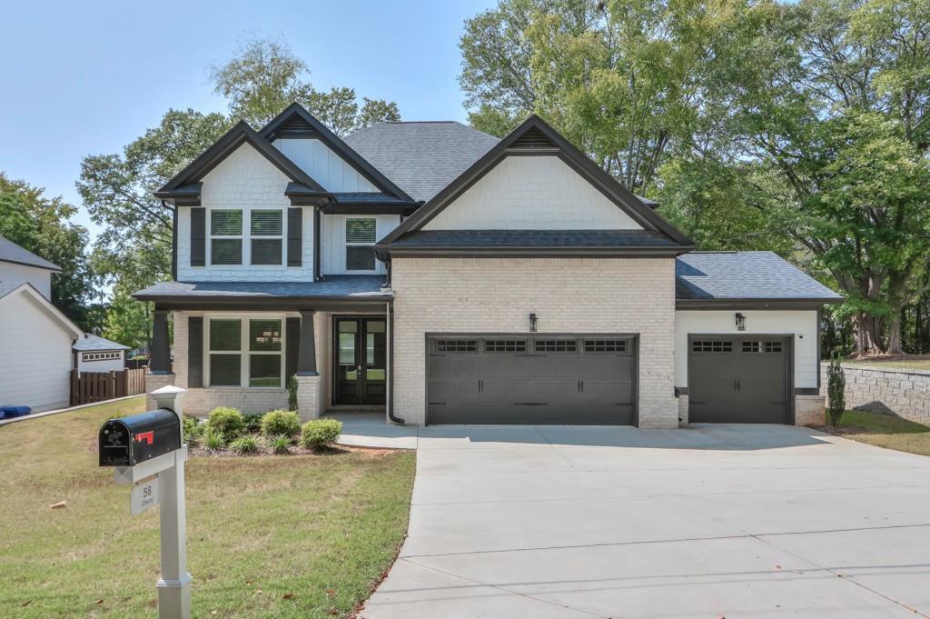 a front view of a house with a yard and garage