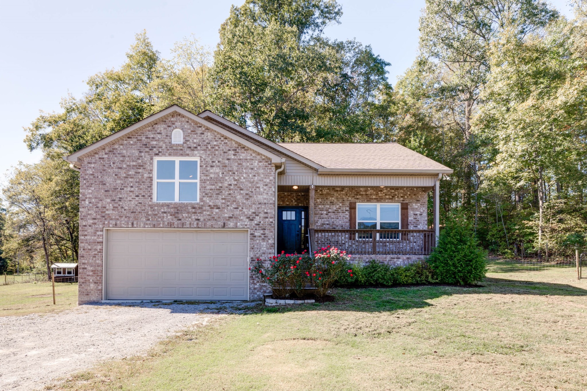 a front view of a house with a garden