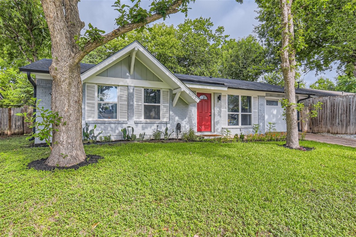 a front view of house with yard and green space