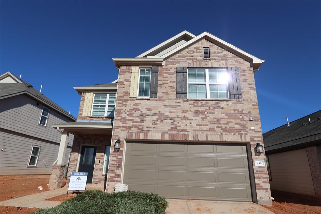 a front view of a house with garage