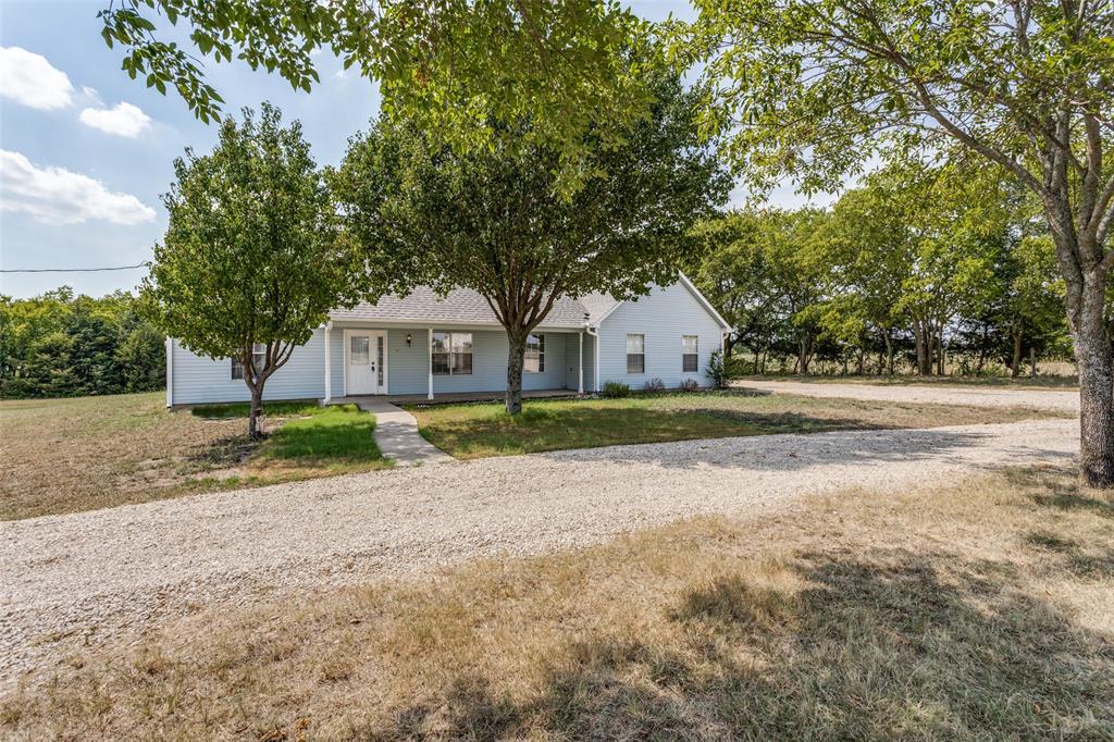 a house that has a tree in front of it