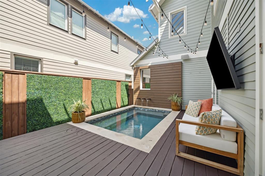 a view of a patio with table and chairs with wooden floor and fence