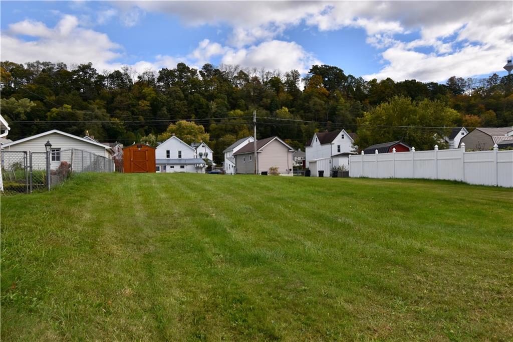 a view of a house with a yard and sitting area