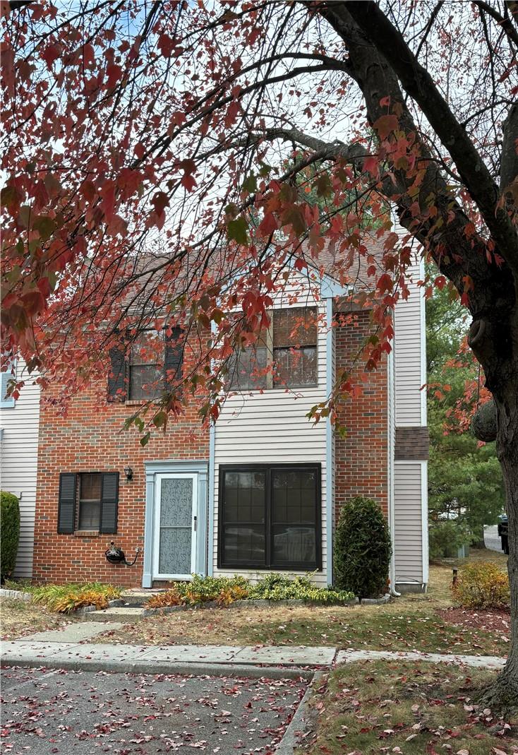 a view of a house with a tree in front