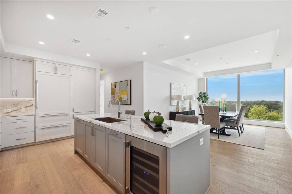 a kitchen with counter top space and living room