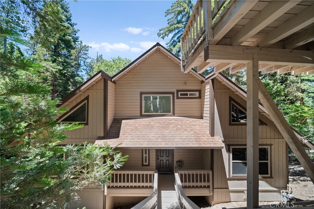 a view of a house with a yard and deck