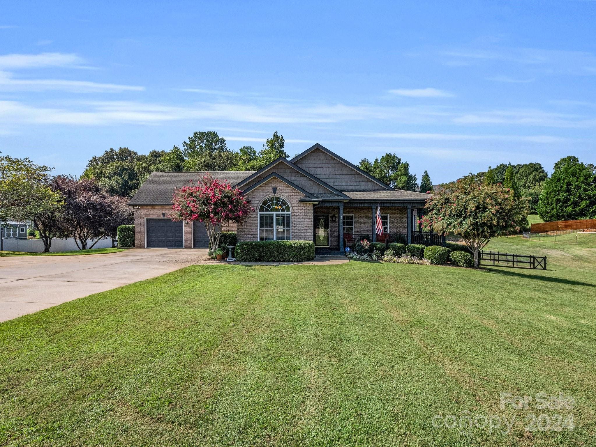 a front view of a house with yard and green space