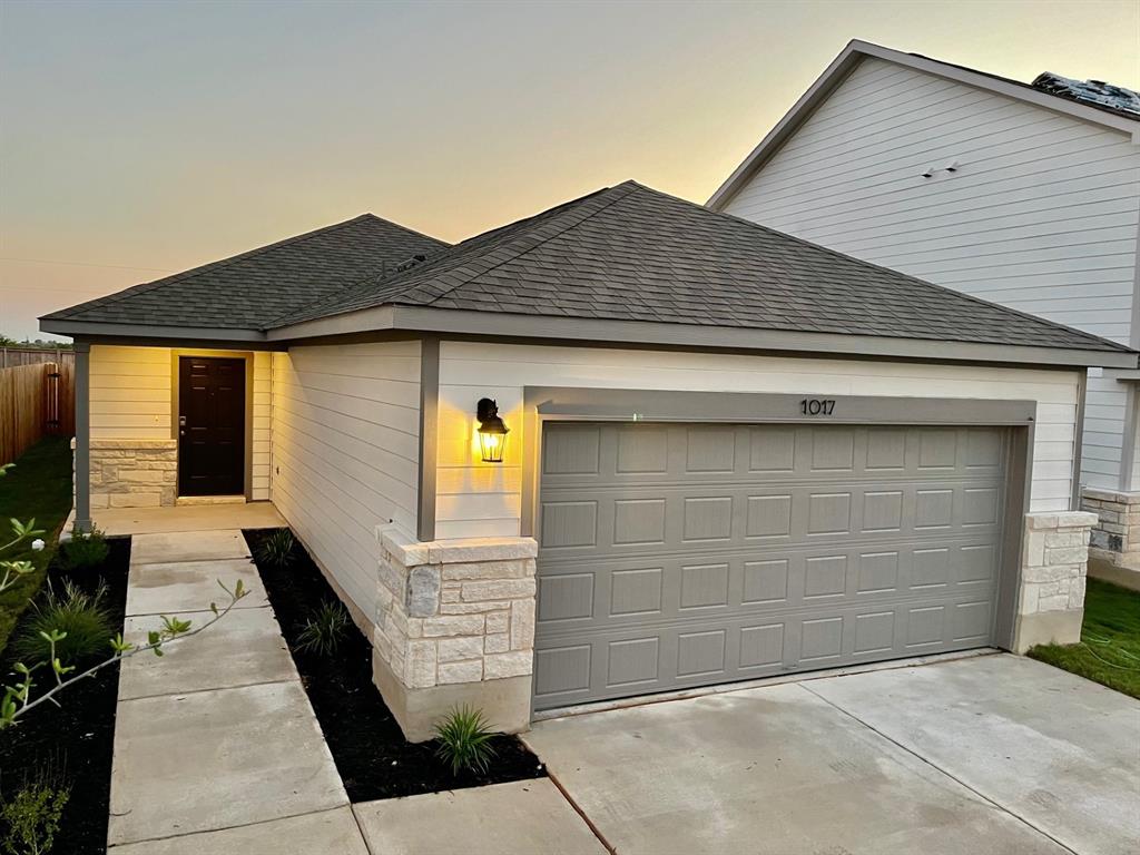 a front view of a house with garage