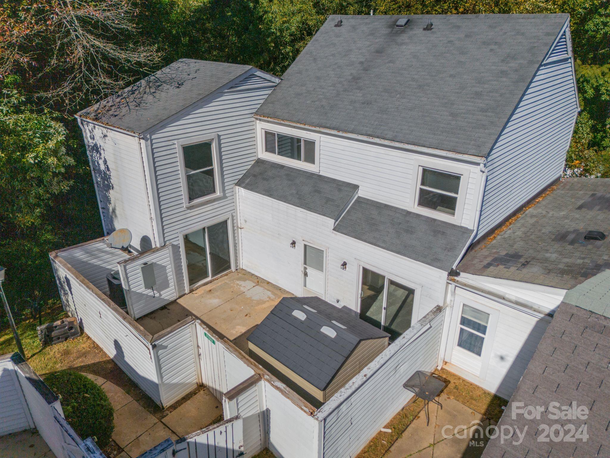 a aerial view of a house with a roof deck