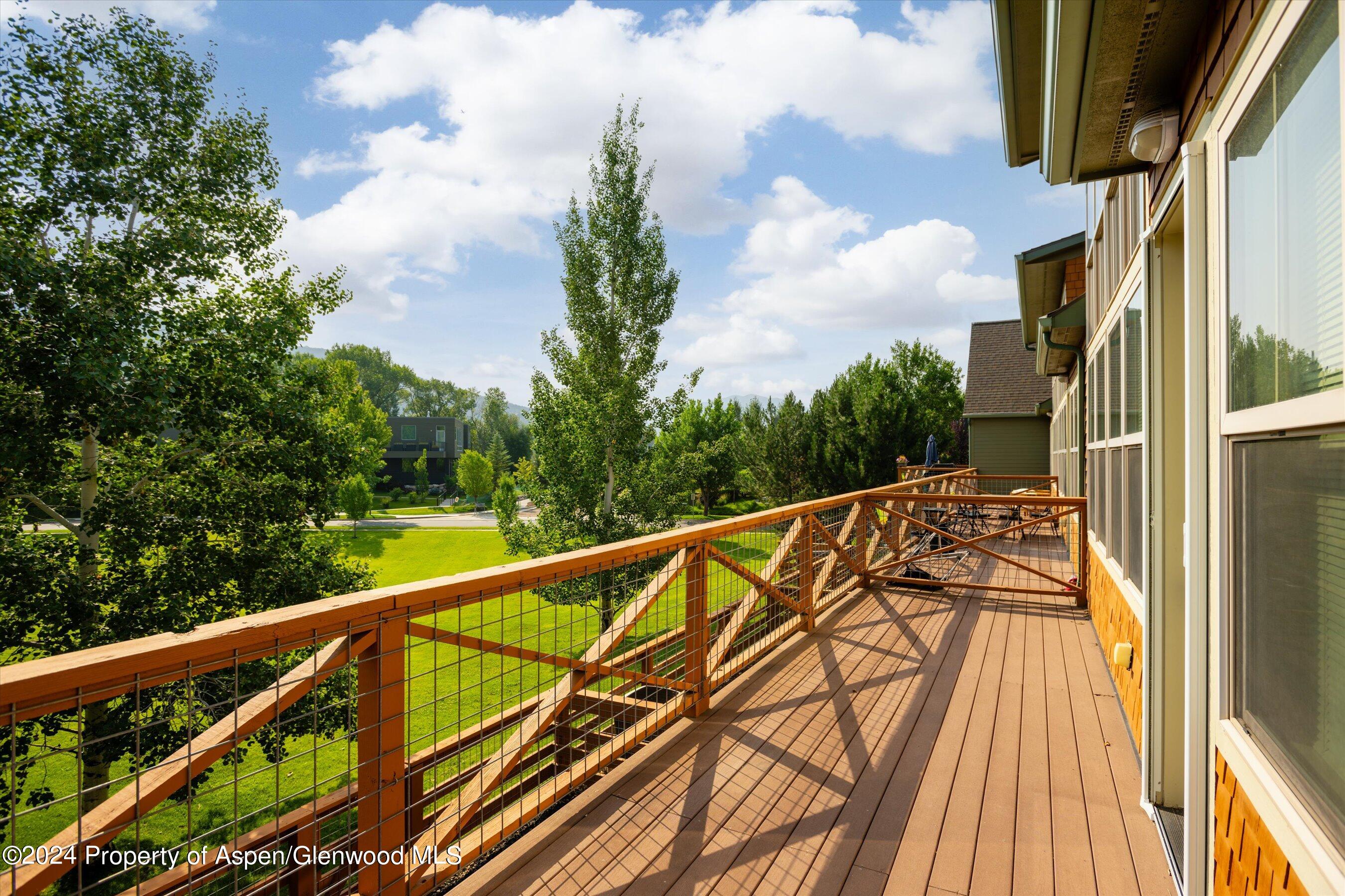 a view of balcony with wooden floor and fence